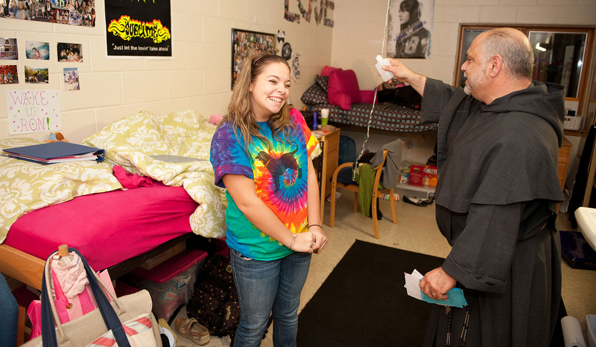 Father Jude blessing a residence hall room
