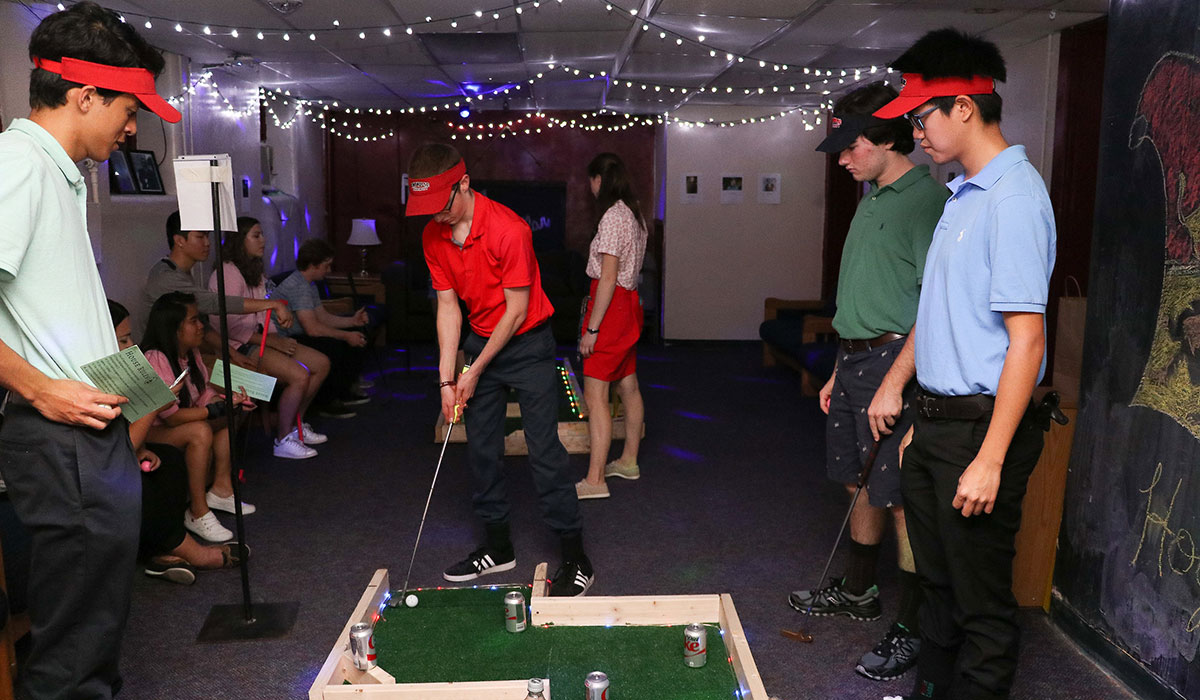 Students playing mini golf