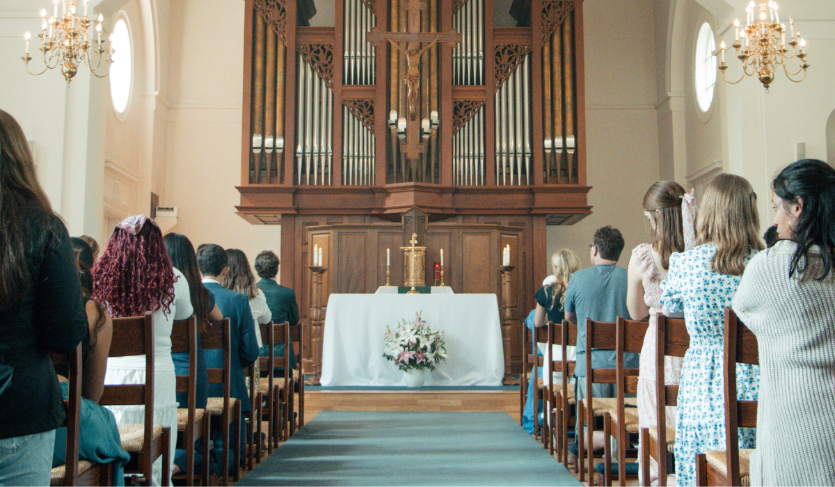 Eucharistic Adoration and candlelit prayer services inside the university chapel