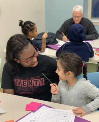 Catholic University student tutoring a child